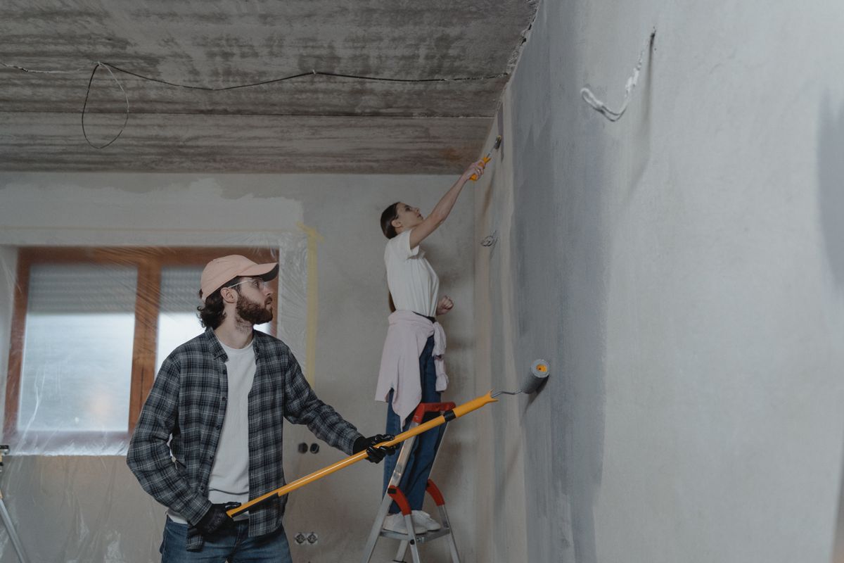 Painter finishing an interior wall with a wide brush