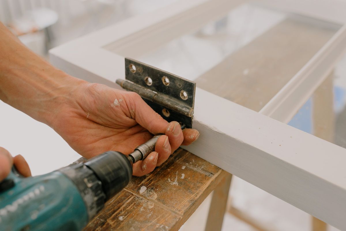 Fitting a hinge to a freshly painted timber door